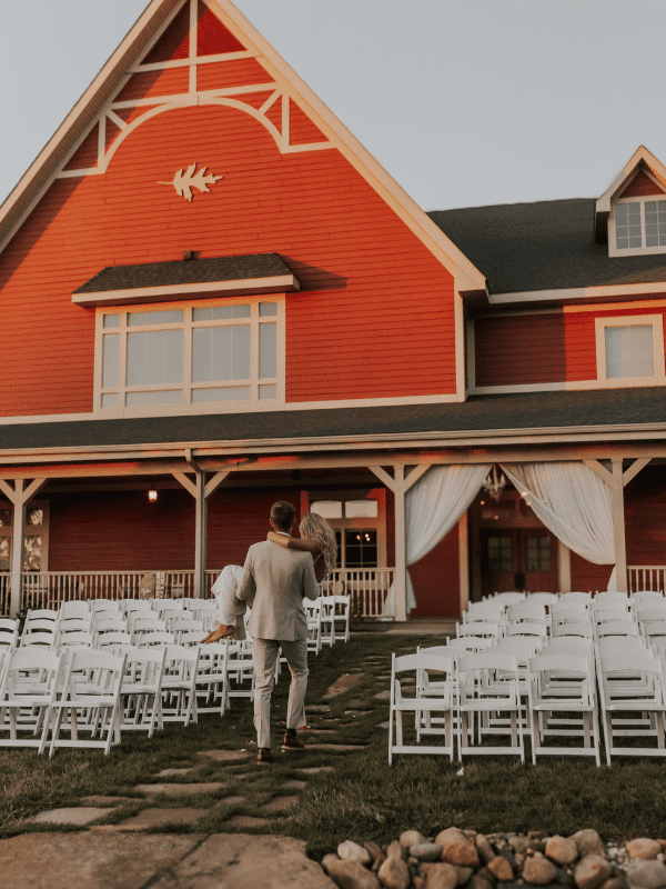 groom carrying bride at wedding at fair oaks farms