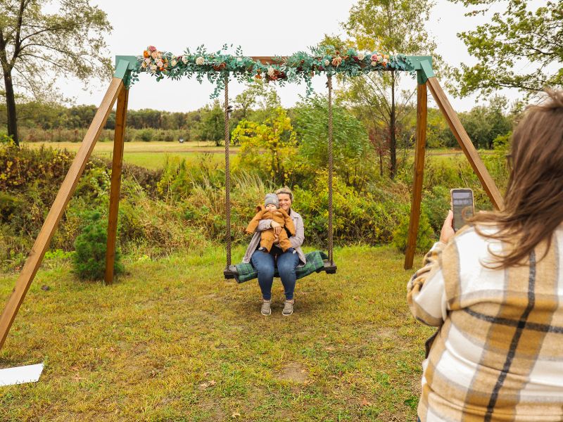 woman sitting on swing with child